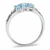 Oval Blue Topaz Three Stone Ring in 10K White Gold - Size 7