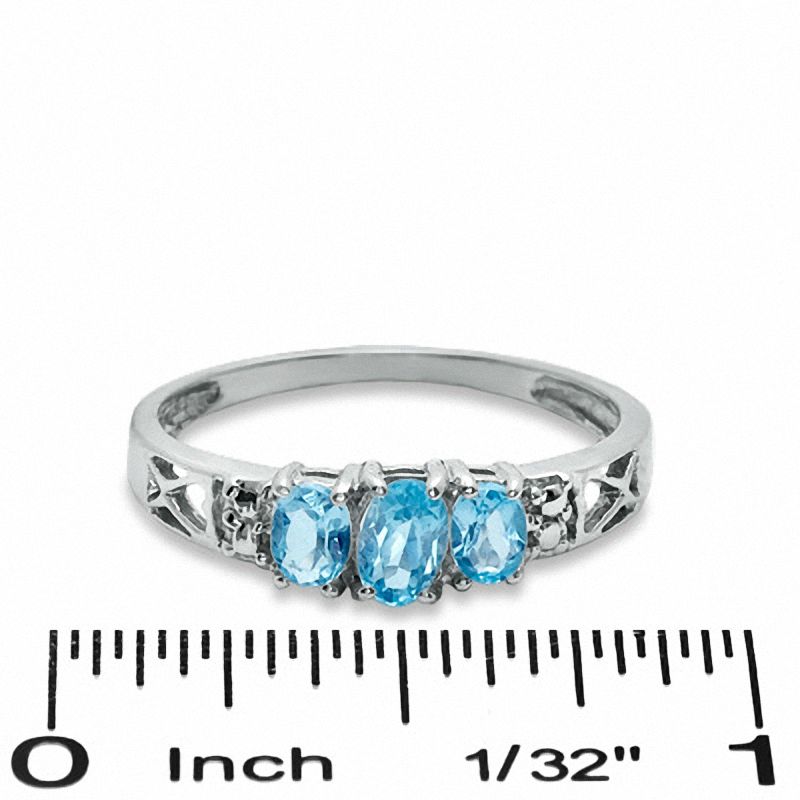 Oval Blue Topaz Three Stone Ring in 10K White Gold - Size 7
