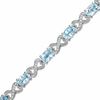 Thumbnail Image 1 of Oval Blue Topaz and Diamond Bracelet in Sterling Silver - 7.25"